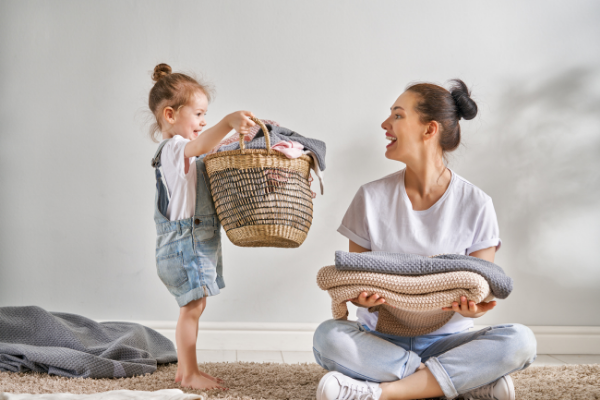 mom and child doing laundry